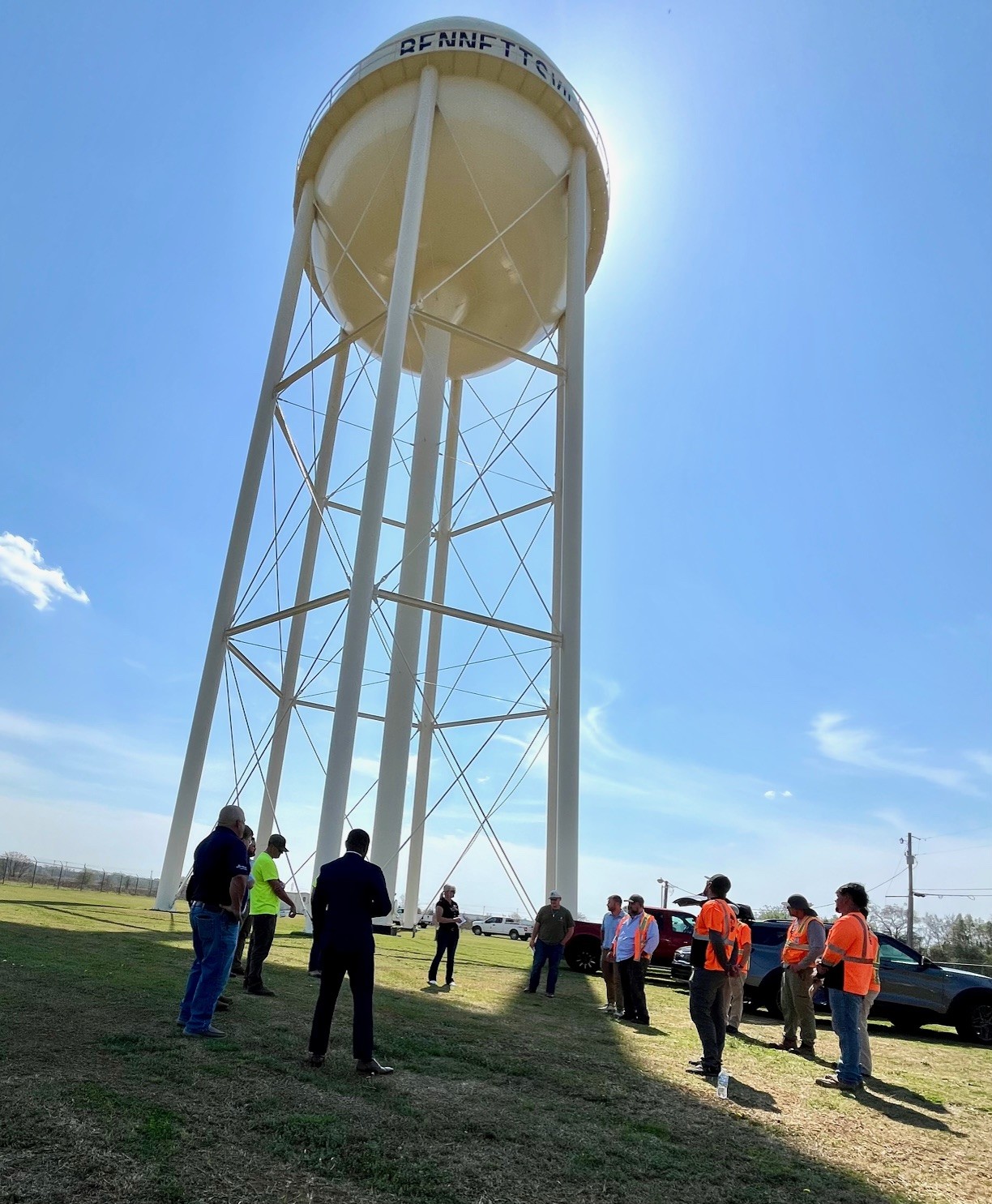 Team of people meeting below water tank
